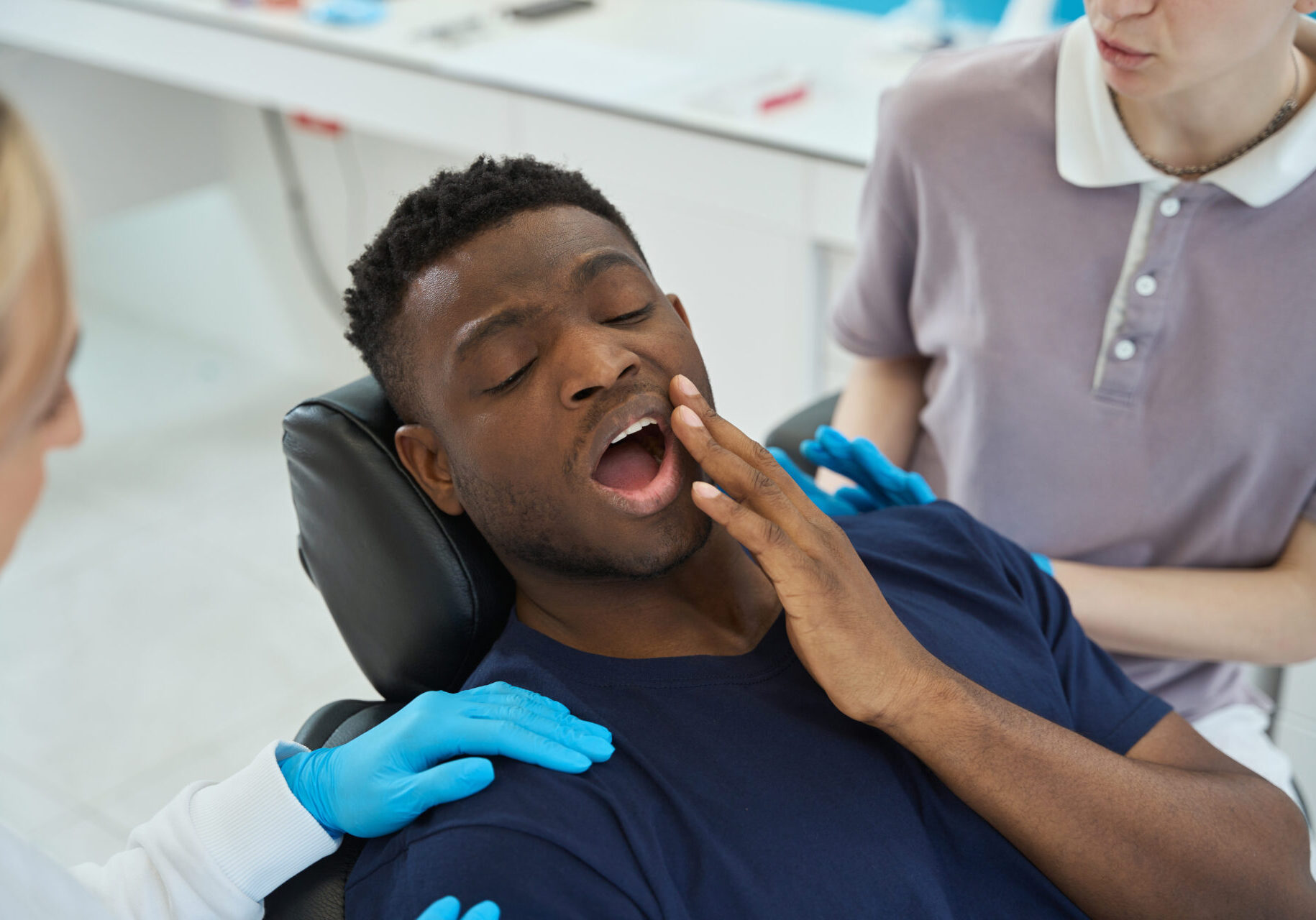Patient with toothache sitting in chair, seeing emergency dentist in Heathmont